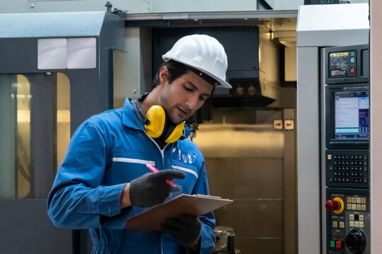 Smart factory worker or engineer do machine job in manufacturing workshop . Industry and engineering concept .