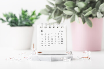 Calendar with pins on white desk