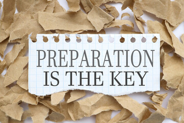 Preparation is the key. text on white paper over torn paper background.
