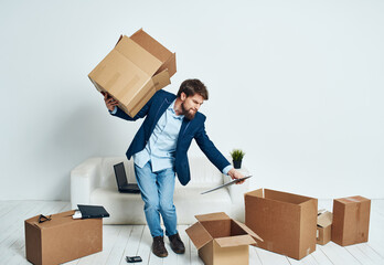 a man with a box of things unpacking a new place office lifestyle official