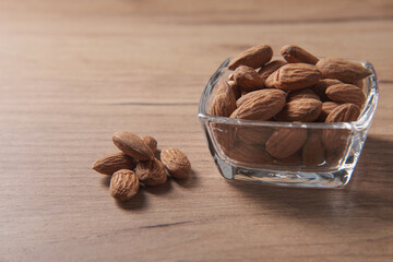 Almonds in a small glass plate, side view