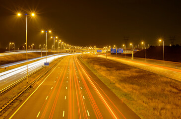 Fototapeta na wymiar City highway at night, orange bright lights