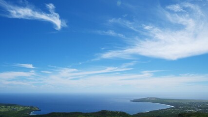Fototapeta na wymiar Beautiful clouds in the blue sky; aerial view of blue sea and coastline