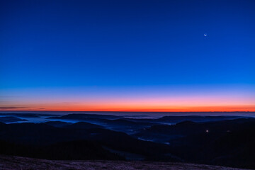 Obraz premium Beautiful scenery after sunset with a moon in the blue sky; shot on October 25, 2019 in Freiburg of Germany