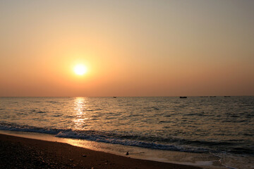 Fototapeta na wymiar Beautiful sunset with orange sky and shimmering sea