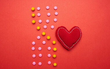 multicolored pills on red background medicine health
