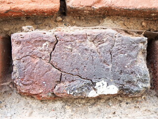 old red bricks in the wall of the house  cracking