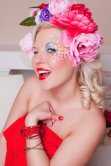 Naklejka premium Beautiful girl in the image of spring with a rim of flowers. 