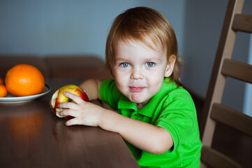 Fototapeta na wymiar Cute boy eating an Apple. Healthy food.
