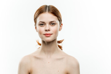 pretty woman with red hair cosmetics naked shoulders femininity light background