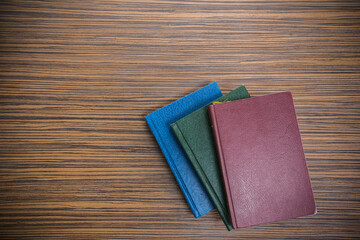 Old books on wooden table, top view.