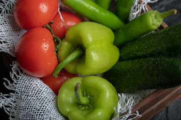 Close up photo of Pile of fresh vegetables in wooden basket over black background