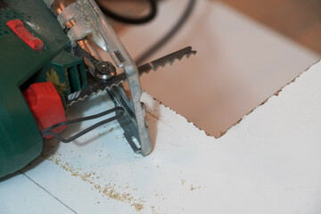 Woodworking. Sawing lumber with an electric saw on patterns. Furniture and facade manufacturing.