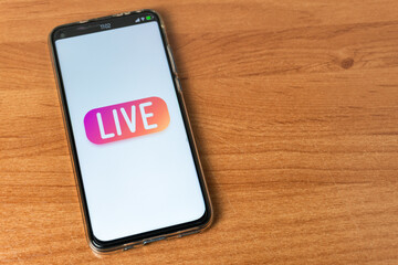 Phone with Live stream logo on table