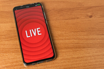 Phone with Live stream logo on table