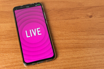 Phone with Live stream logo on table