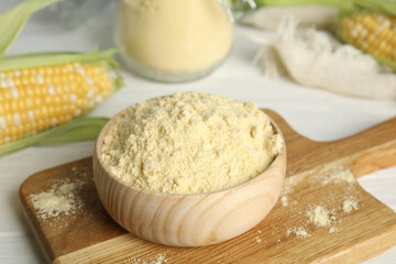 Corn flour in bowl on wooden board