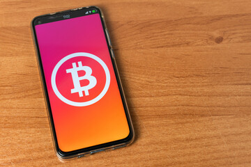 Phone with Bitcoin logo on table