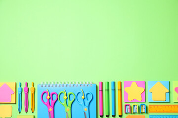 Different school stationery on green background, flat lay. Space for text