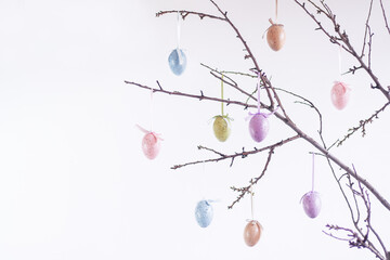 decoration in the form of Easter eggs on tree branches on white background. easter background.