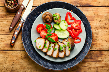 Cutting meat steak with vegetables