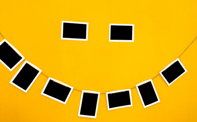 Many pictures frames on the yellow wall