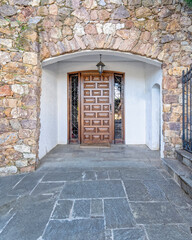 contemporary house main entrance natural wood door and stone covered portico, Athens Greece