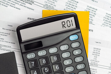 Calculator with the text ROI - Return on Investment on display