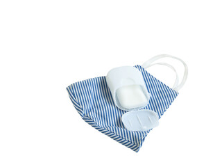 Fabric face mask blue-white stripes and portable soap sheet isolated on a white background. Concept of coronavirus outbreak and pollution. New normal.