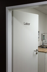 a half open door to the laboratory  room in a doctor's surgery