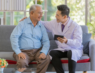 A young asian male doctor with short black hair wearing white lab coat hugging old fat patient who...