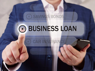  BUSINESS LOAN text in list. Manager looking for something at smartphone. A business loan is a loan specifically intended for business purposes