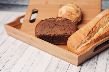 Fototapeta na wymiar whole grain bread loaves homemade cakes cooking wood board close-up