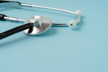 Stethoscope on blue background with a copy space. Medical concept.