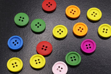 close-up colorful buttons for sewing on black background