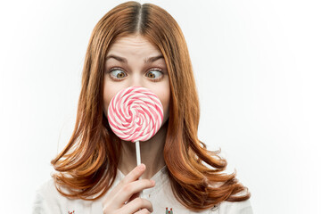 cute red haired woman with lollipop behold street delight sweets light background