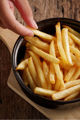 French fries with ketchup on a dark wood background. fastfood snack.