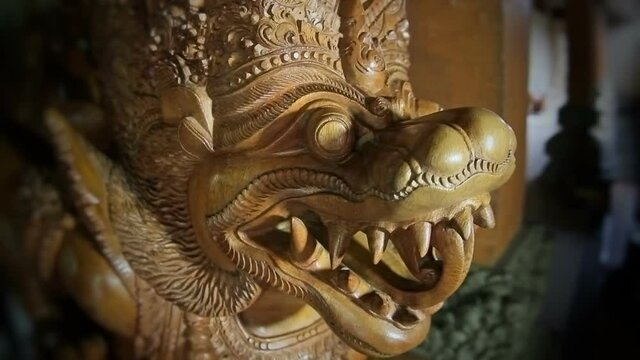 Bali wood sculpture. Moving the camera and hitting it with focus on the face.
