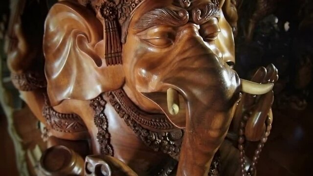 Bali wood sculpture. Moving the camera and hitting it with focus on the face.