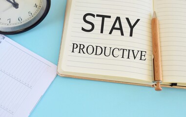 Fototapeta na wymiar Stay Productive Motivation quote written in Notebook. Business concept for Concentration Efficiency Productivity.