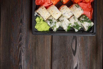 set of sushi and rolls wooden sticks top view ginger wasabi
