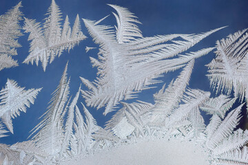 Snow patterns on the glass on a frosty February day. Russia.