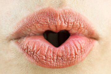 Fototapeta premium Women's lips in the form of a heart. Love, sexuality and happiness concept.