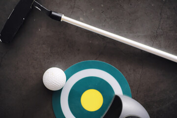 Sport and healthy lifestyle. Mini golf. White golf ball and set for minigolf on the table. Sports background with golf concept.