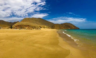 sand beach and sky with clouds