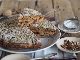 Close-up.Round homemade fruit cake on a wooden ancient table.