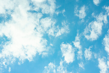 Blue sky with many fluffy different shape white clouds