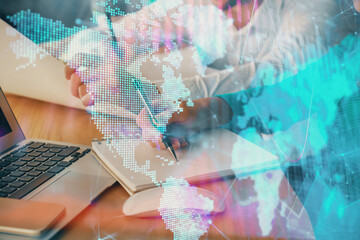 Double exposure of forex chart drawing over people taking notes background. Concept of financial analysis