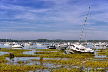 Sailboats at low tide at Arès, ostreicole commune located on shore of Arcachon Bay, in the Gironde department in southwestern France.
