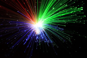 Fototapeta premium Light explosion effect background. Flying lights blue, red, green. Big bang effect. Fireworks.